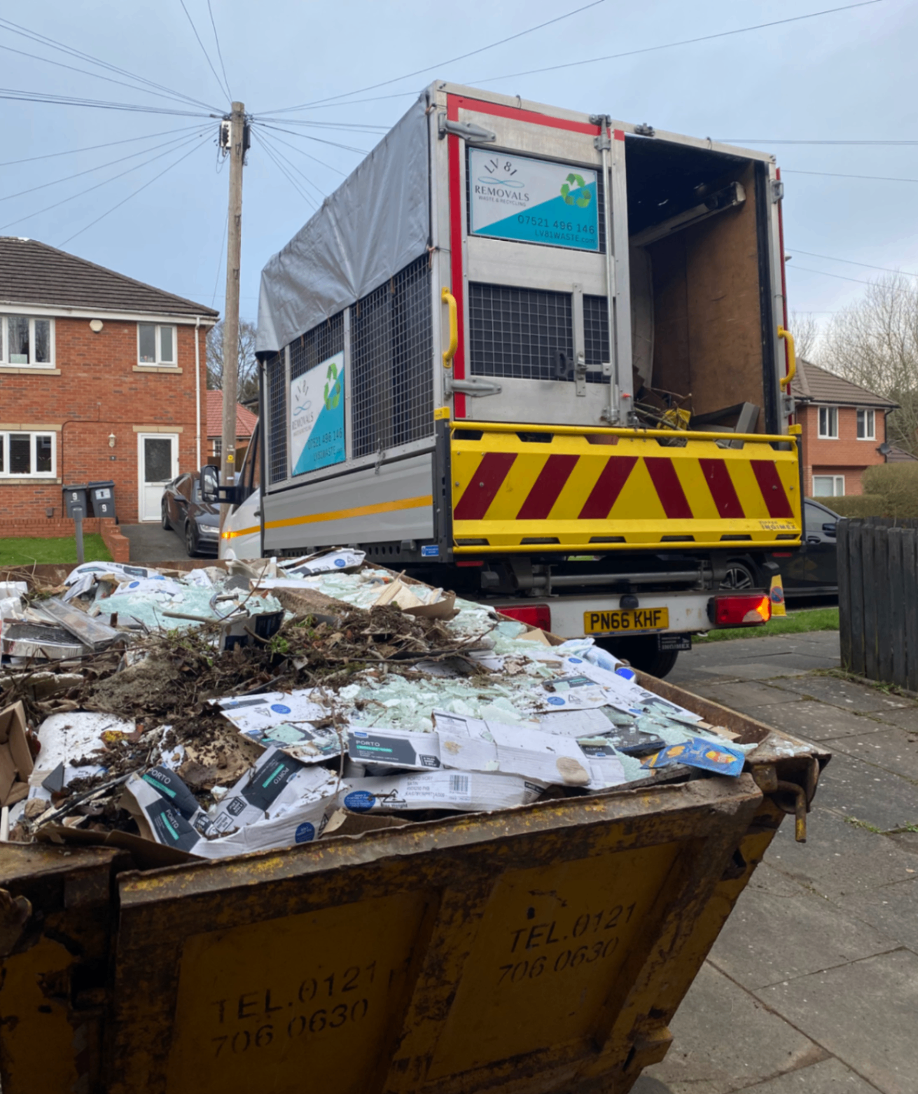 Loaded tipper truck beside a skip during a bulky waste clearance