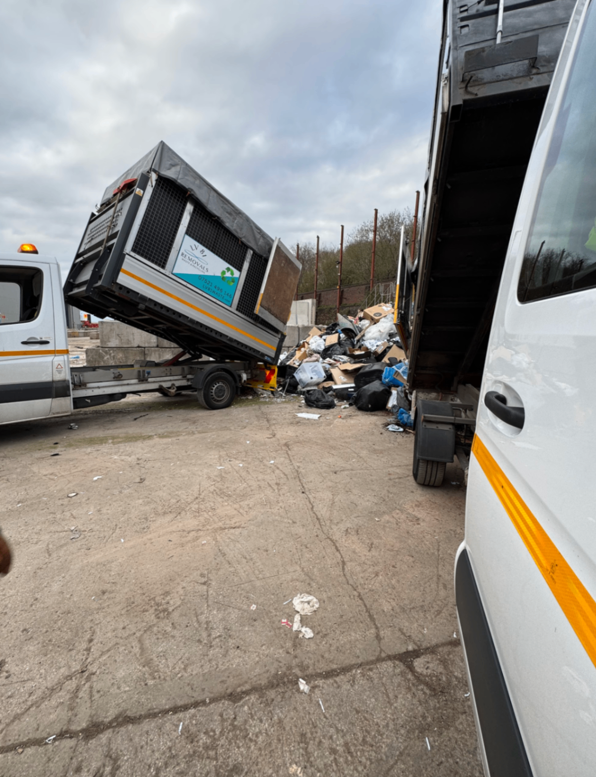Tipper van raised while unloading waste at a disposal site