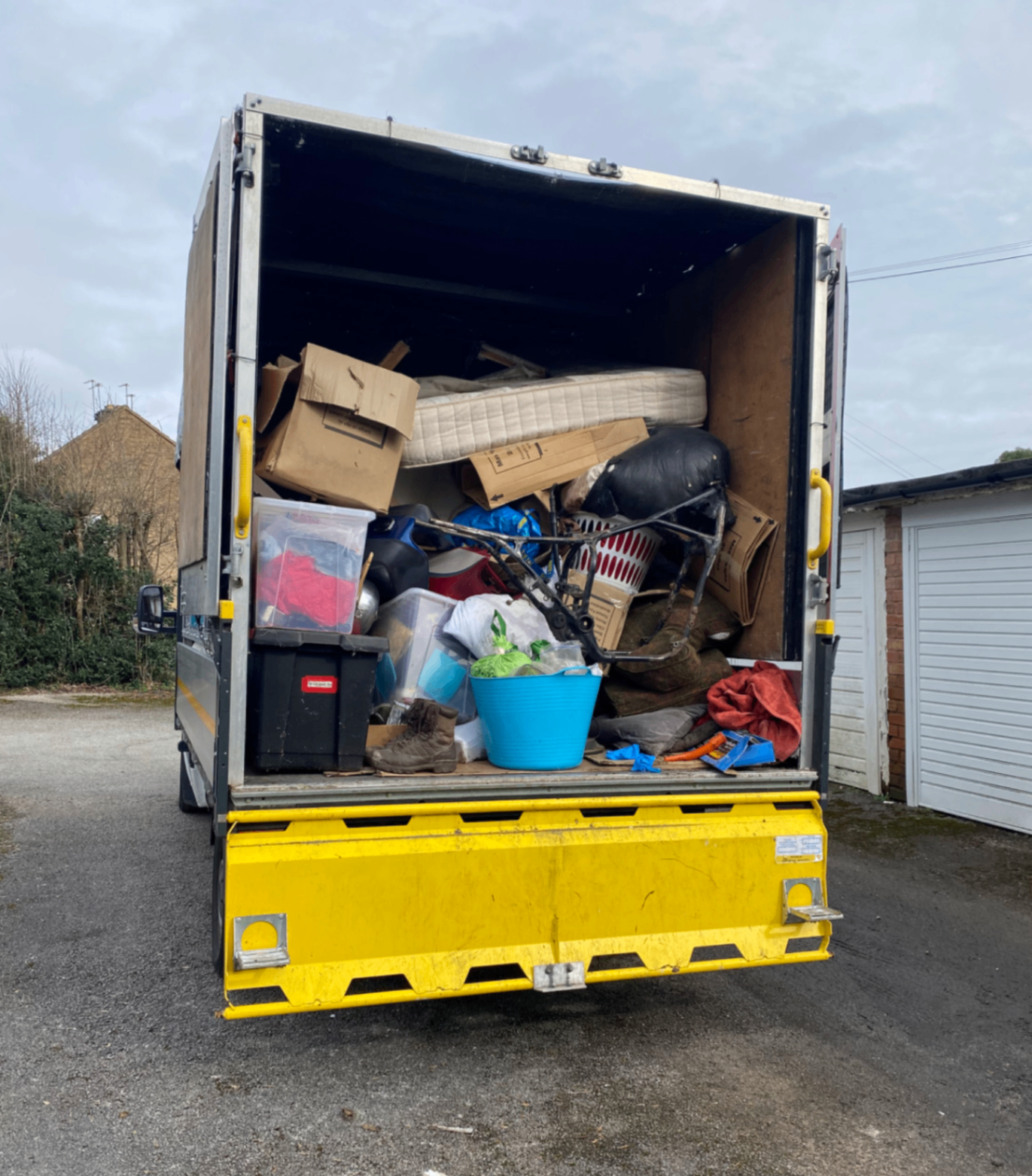 Household clearance loaded into the truck including furniture and storage boxes