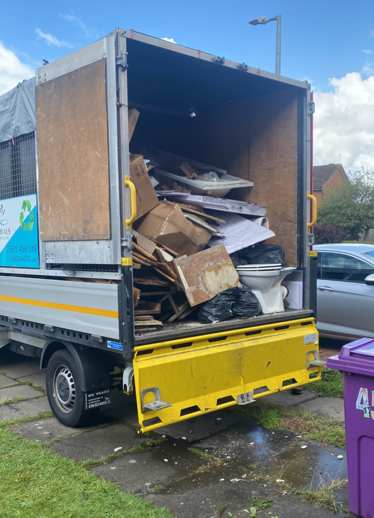 Bathroom rip-out waste including sanitaryware and timber loaded for disposal