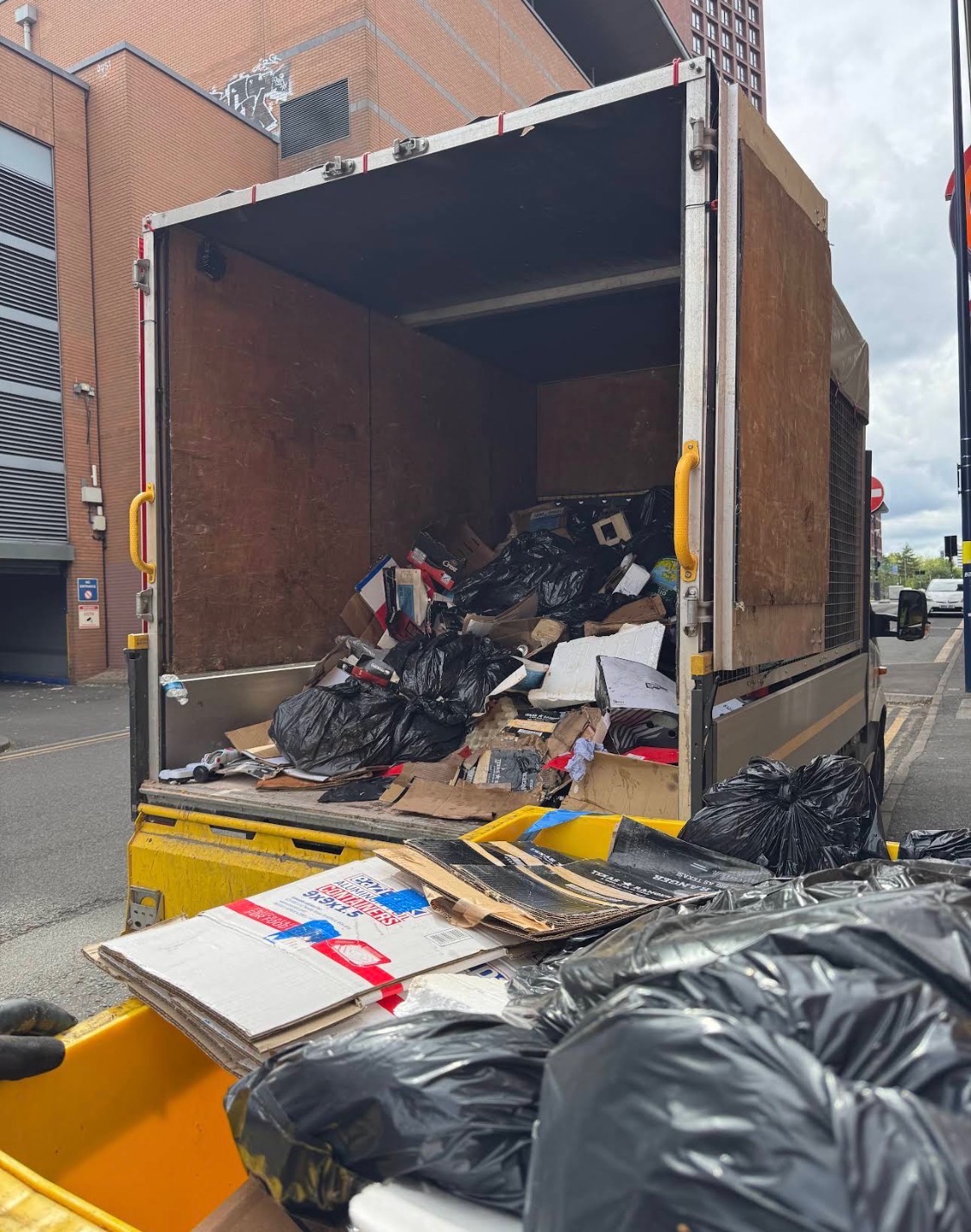 LV81 Removals Luton van loaded with bagged and cardboard waste in Birmingham city centre