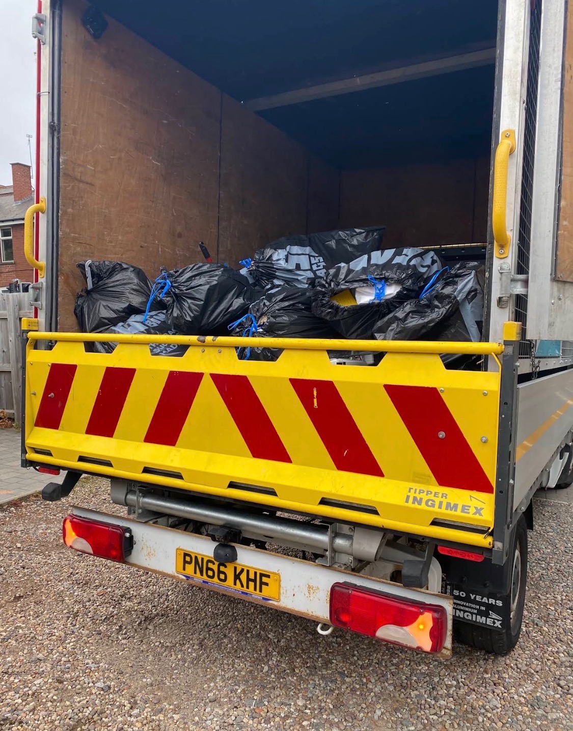 Bagged household rubbish loaded on LV81 Removals tipper